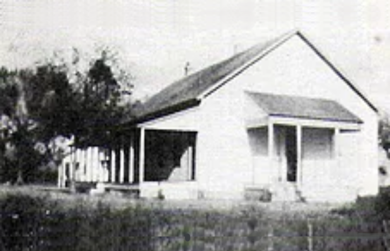 A black and white photo of an old house.