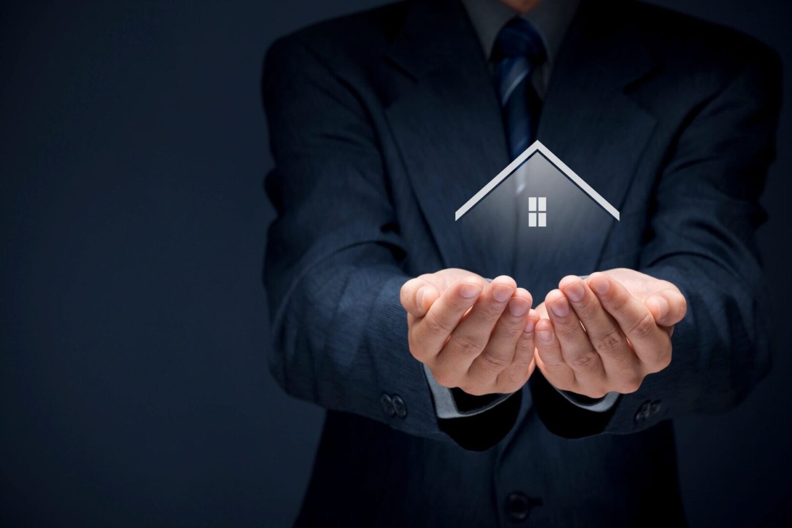 A man holding out his hands with a house in the middle.